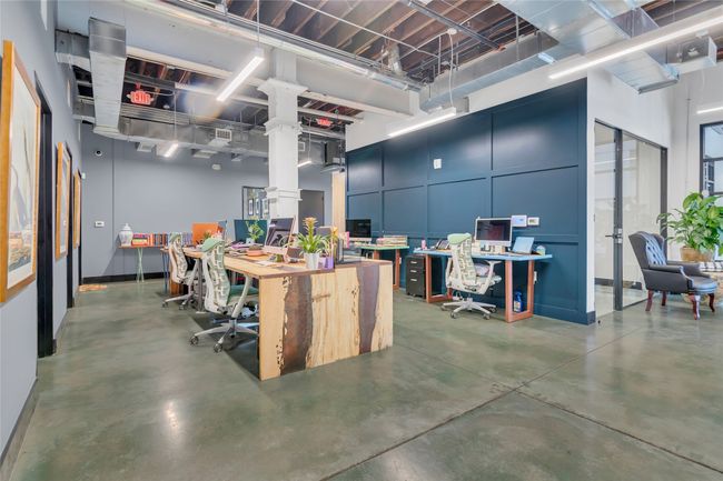 Misc room with finished concrete flooring and an office area | Image 11