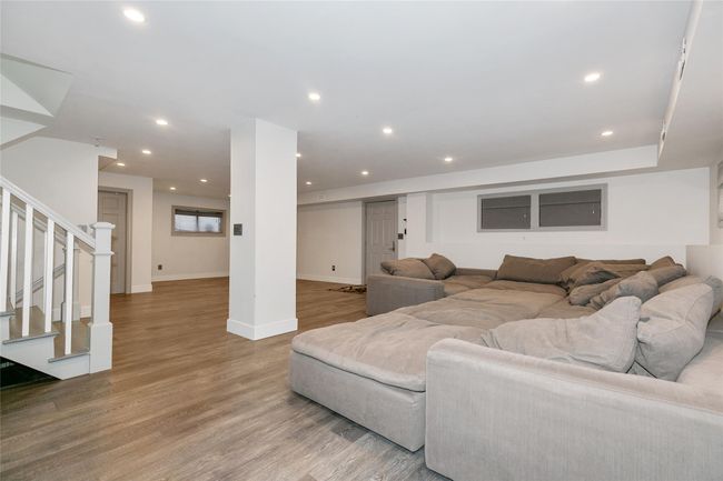 Living area featuring stairway, wood finished floors, recessed lighting, and baseboards | Image 23