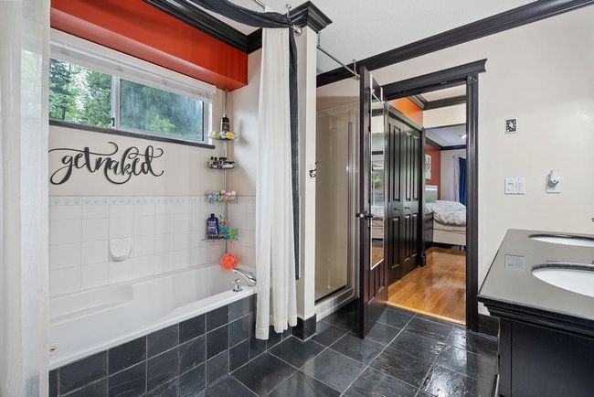 Bathroom with a stall shower, crown molding, a sink, a garden tub, and ensuite bath | Image 22