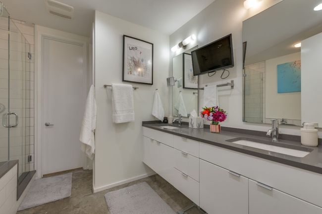 Bathroom with a shower with door and vanity | Image 26