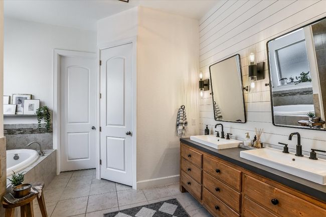 Full bath featuring a sink, a bath, and double vanity | Image 18