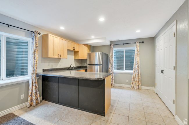 Kitchen with baseboards, light brown cabinets, freestanding refrigerator, and recessed lighting | Image 20