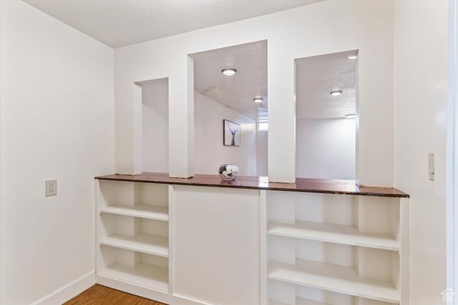 Detailed view of baseboards and wood finished floors | Image 22