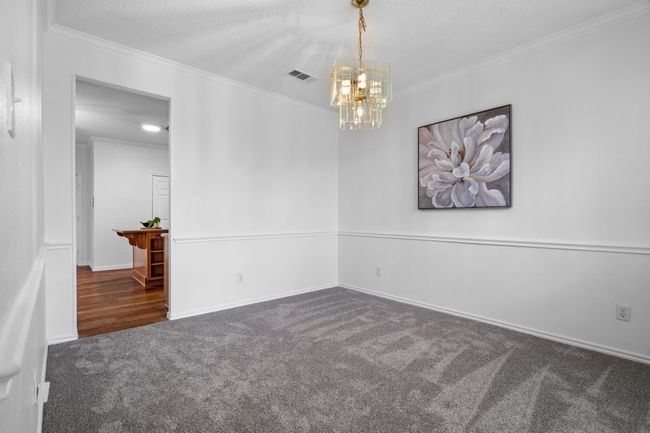 The formal dining room opens to the kitchen. | Image 9