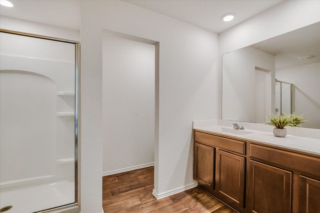 Bathroom with vanity, wood finished floors, baseboards, recessed lighting, and a shower stall | Image 12
