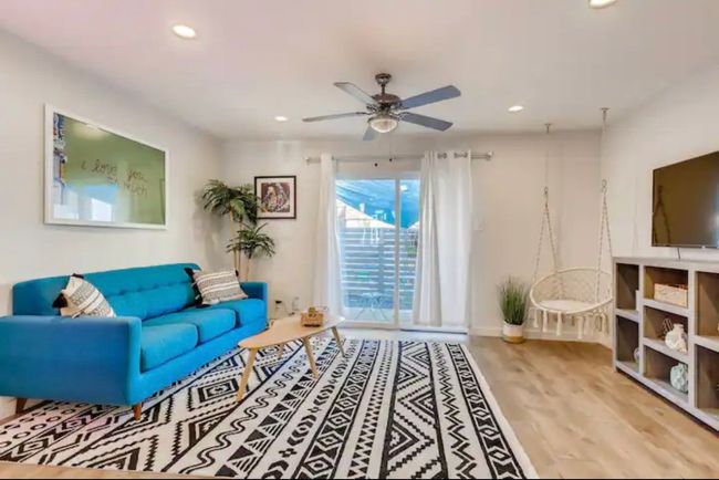 Living area featuring wood finished floors, baseboards, a ceiling fan, and recessed lighting | Image 5