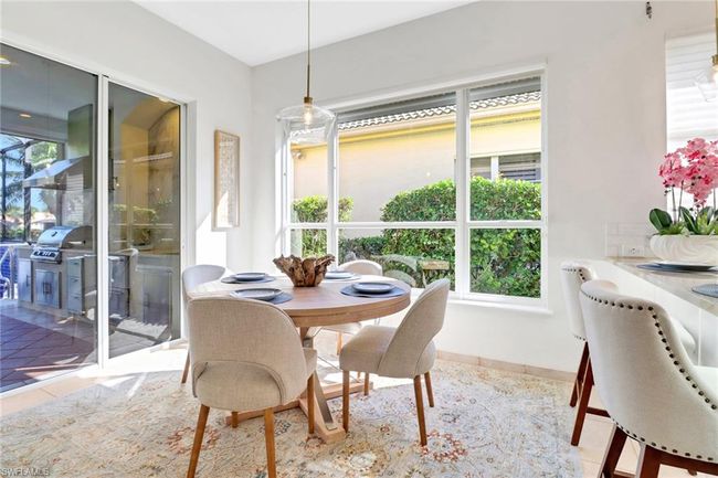 Dining space featuring tile patterned flooring, baseboards, and a wealth of natural light | Image 12
