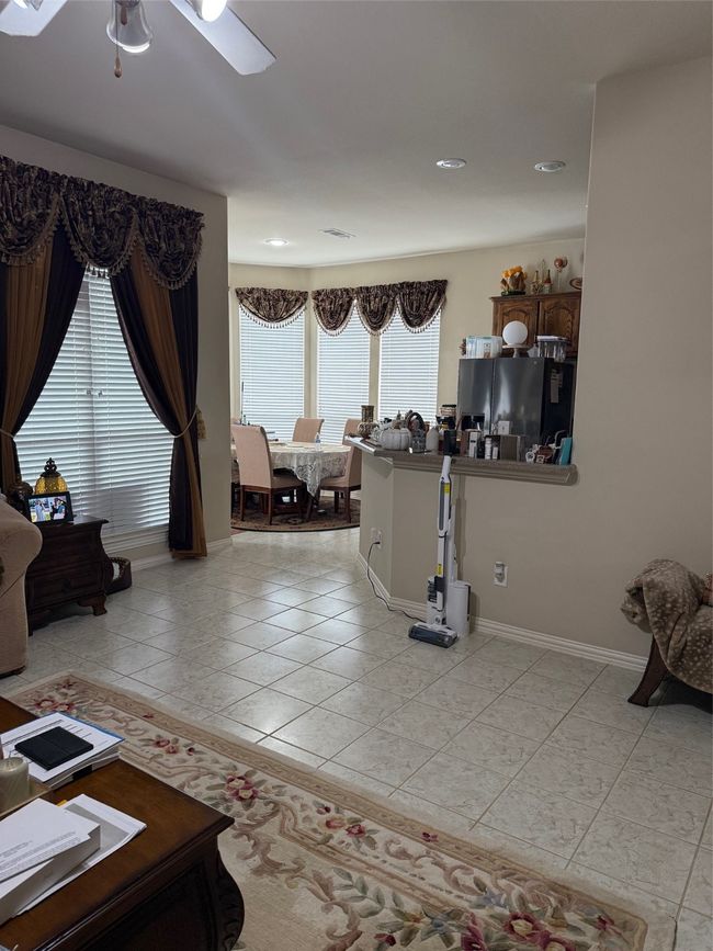 Living room with ceiling fan, light tile patterned flooring, baseboards, and recessed lighting | Image 19
