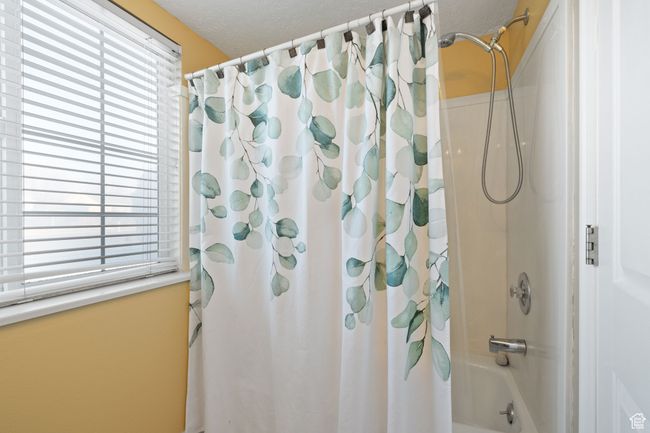Bathroom featuring shower / tub combo with curtain and plenty of natural light | Image 33