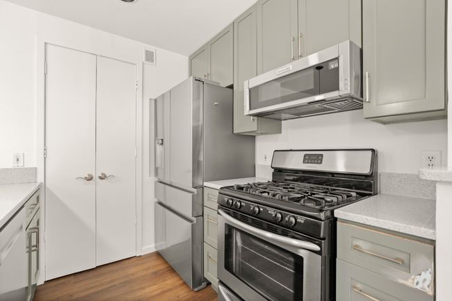 Newly painted cabinets, custom built for the space to maximize storage. The laundry and pantry share the closet. | Image 16
