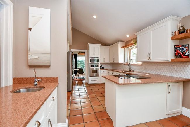 Here's a great, complete view of the kitchen (facing the dining area, straight ahead), including a handy wet bar, left, great for entertaining. | Image 19