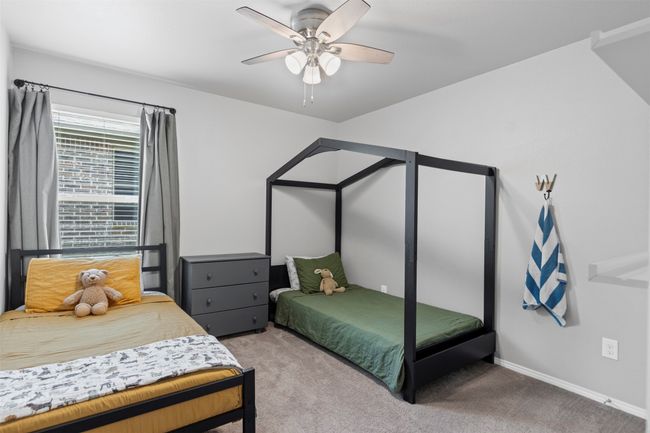 Carpeted bedroom featuring ceiling fan and baseboards | Image 9