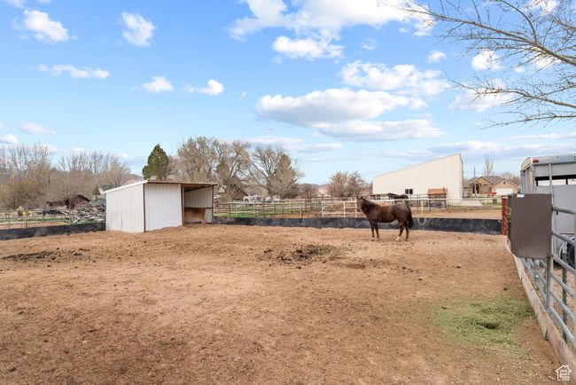 View of yard with an exterior structure, an outdoor structure, a rural view, and a pole building | Image 33
