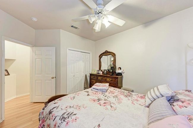Bedroom featuring light wood-style flooring, a closet, and a ceiling fan | Image 27