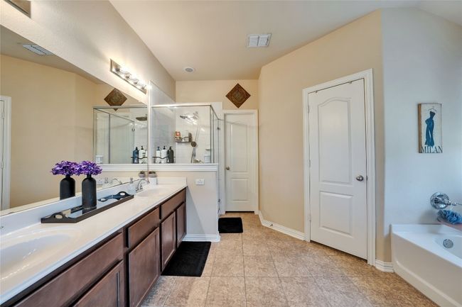 Main bath features dual vanity, ample storage, and private main restroom | Image 15