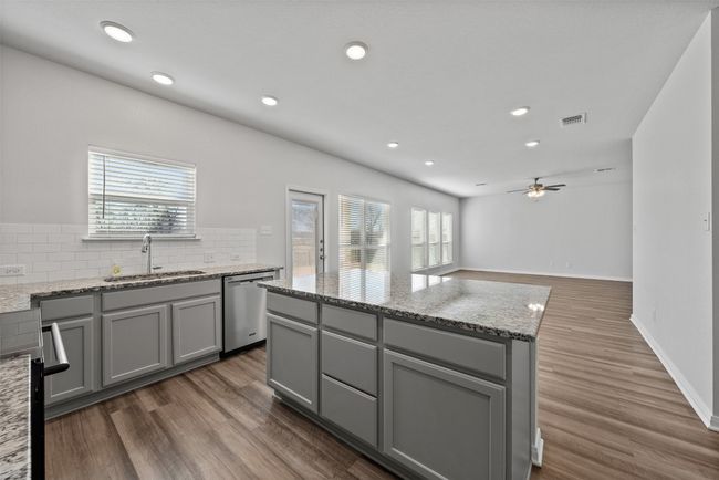 Kitchen featuring stainless steel appliances, gray cabinetry, tasteful backsplash, a ceiling fan, and recessed lighting | Image 13