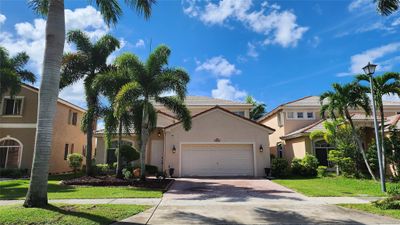 GORGEOUS 2-STORY HOME SWEET HOME! Front North exposure, paved driveway laced w/ palm trees! | Image 1