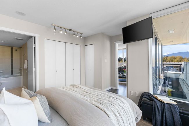 Bedroom with multiple windows, multiple closets, visible vents, and ensuite bathroom | Image 12