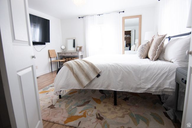 Bedroom featuring wood finished floors and baseboards | Image 20