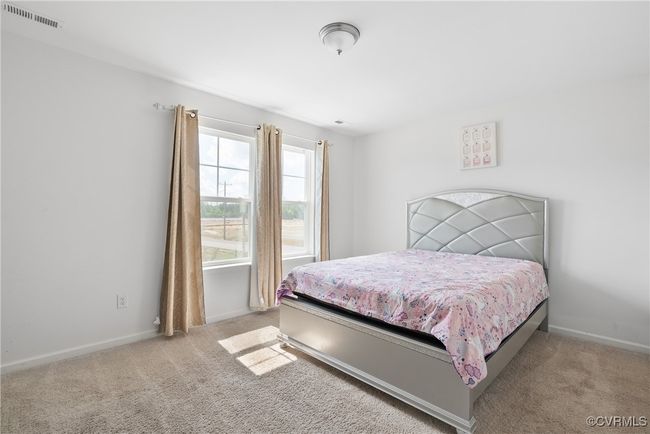 Carpeted bedroom with baseboards and visible vents | Image 26