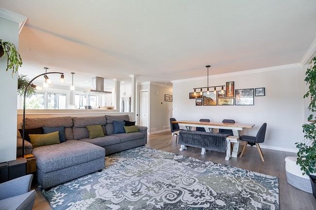 Living area featuring baseboards, crown molding, and wood grain laminate floors | Image 6
