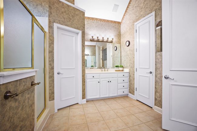 Bathroom with vanity, tile patterned floors, a shower stall, and wallpapered walls | Image 18