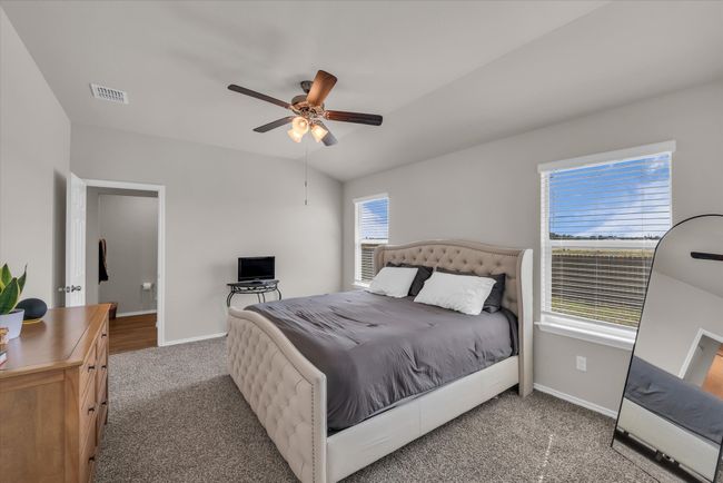 Bedroom featuring carpet flooring, baseboards, and ceiling fan | Image 10