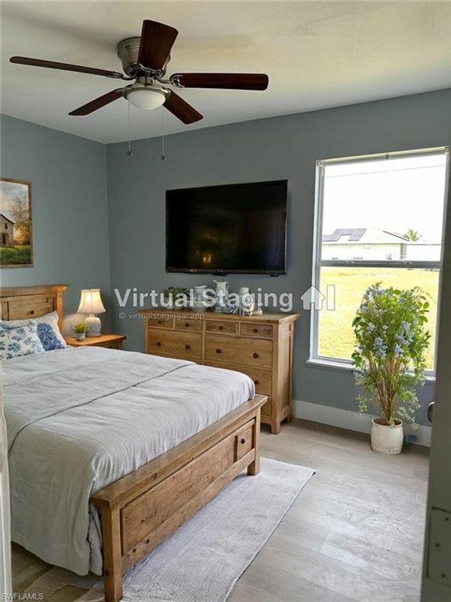 Bedroom with light wood finished floors and a ceiling fan | Image 18