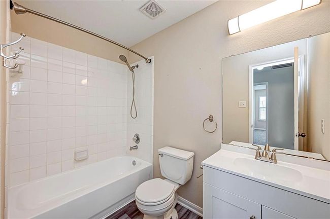 The hall bathroom is located between the two secondary bedrooms. | Image 35