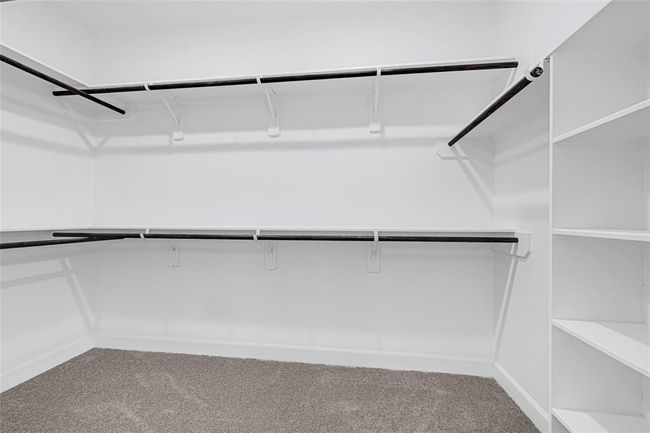 Walk-in closet next to primary bathroom. | Image 17