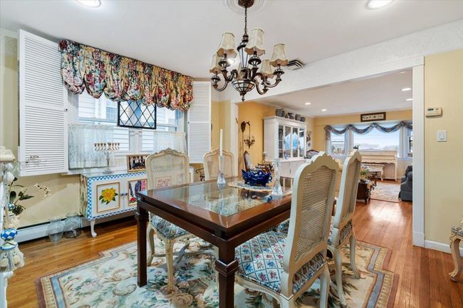 Dining area featuring recessed lighting, a notable chandelier, and wood finished floors | Image 9