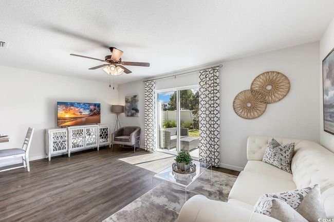 Living room with wood finished floors and ceiling fan | Image 6