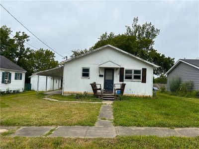 View of front of property featuring a carport and a front yard | Image 1