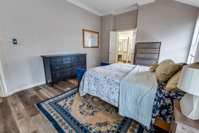Large primary suite with crown molding and luxurious spa-bath. | Image 21