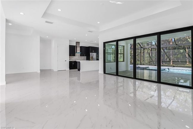 Tiled spare room with a tray ceiling | Image 15