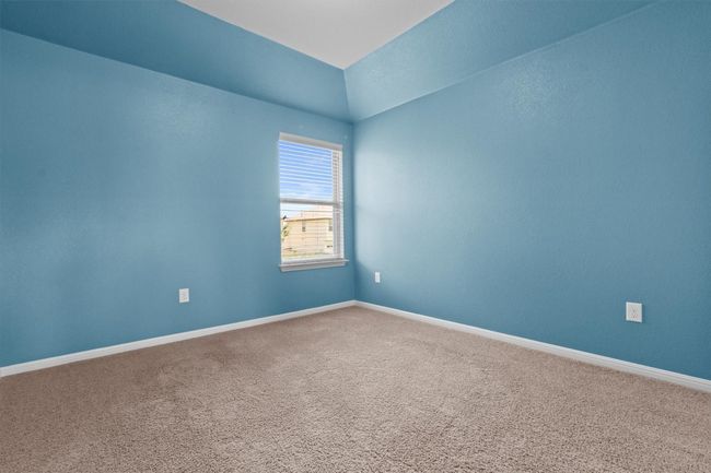 Unfurnished room featuring carpet flooring, baseboards, and vaulted ceiling | Image 26