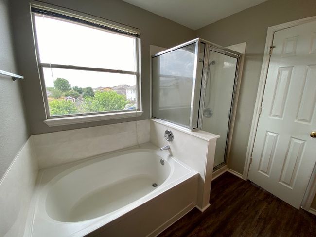 Full bath with a garden tub, a shower stall, and wood finished floors | Image 24