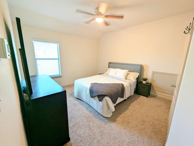 Bedroom with carpet and a ceiling fan | Image 13