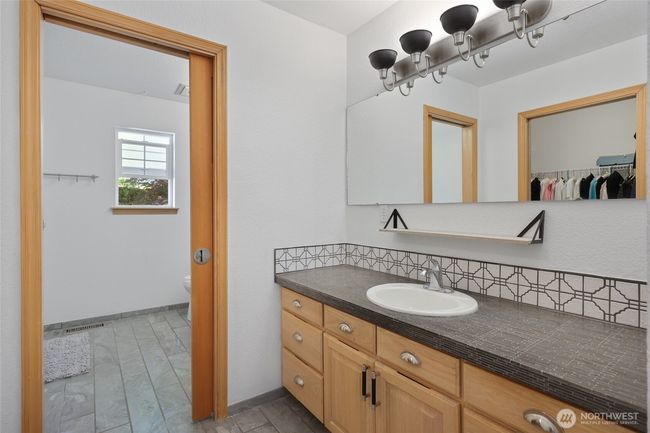 Pocket door separates the shower area and toilet from 2 vanities. | Image 30