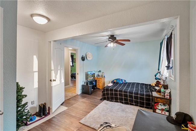 Bedroom with wood-type flooring and a textured ceiling | Image 41