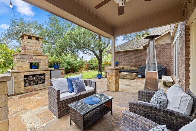 View of patio / terrace featuring an outdoor living space with a fireplace, ceiling fan, and grilling area | Image 27