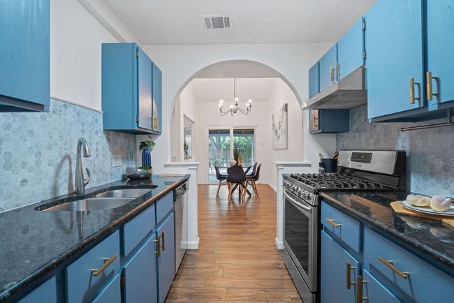 Kitchen featuring cool arched entry | Image 8