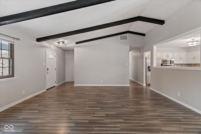 unfurnished living room featuring dark wood-style flooring | Image 17