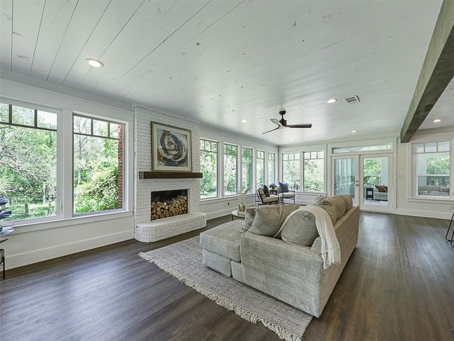 Living area featuring a fireplace, dark wood finished floors, visible vents, and baseboards | Image 18