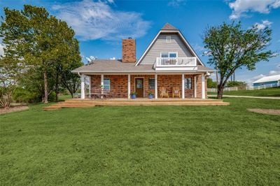 Front of property featuring a yard and covered porch | Image 1