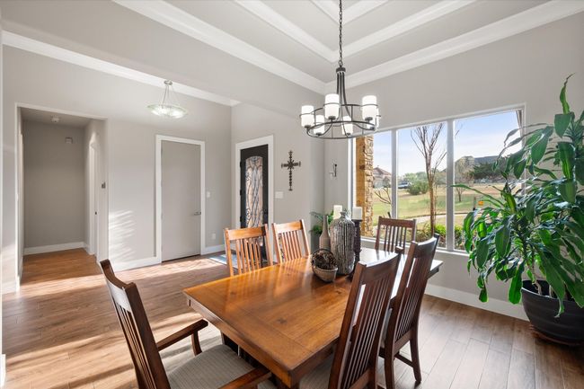 Formal dining with designer ceiling featuring lots of crown molding and beautiful plate glass windows. | Image 6