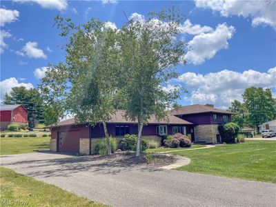 View of front facade featuring a front yard and a garage | Image 3