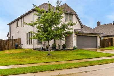 View of front facade with a garage and a front lawn | Image 2