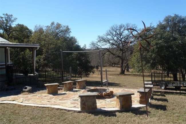 View of yard featuring an outdoor fire pit | Image 14