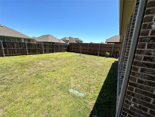 View of yard with a fenced backyard | Image 12